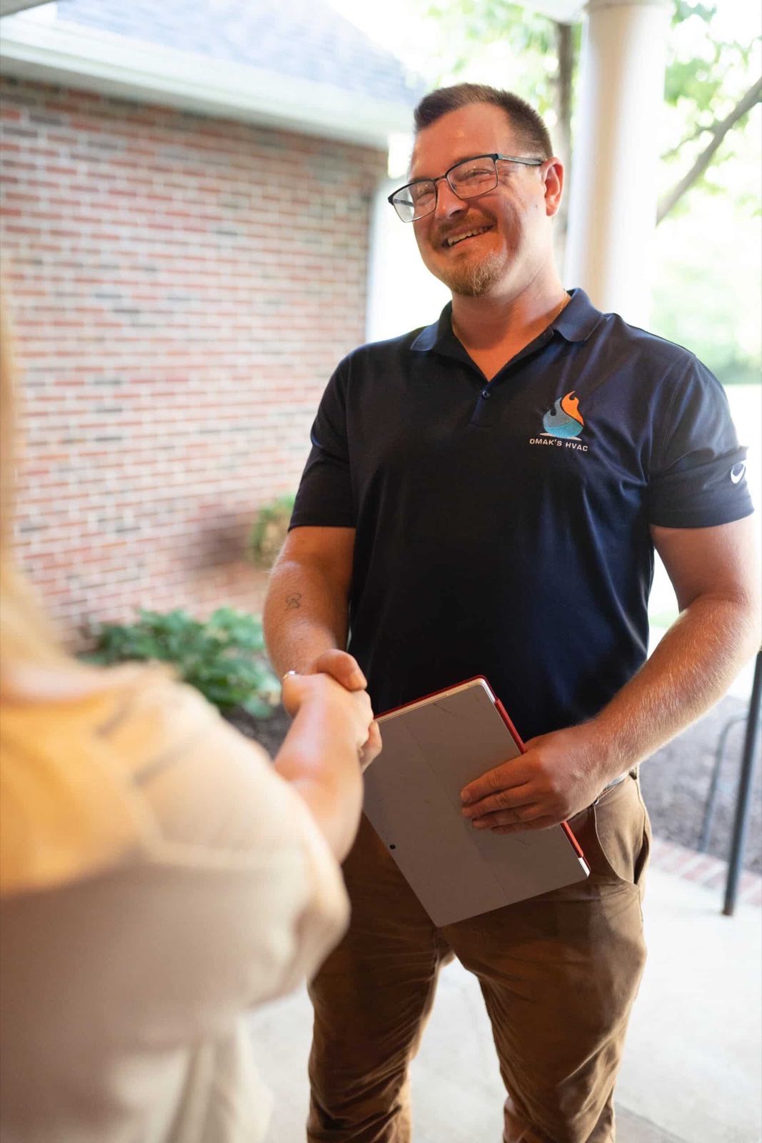 Daniel Makarov greeting a customer at their door